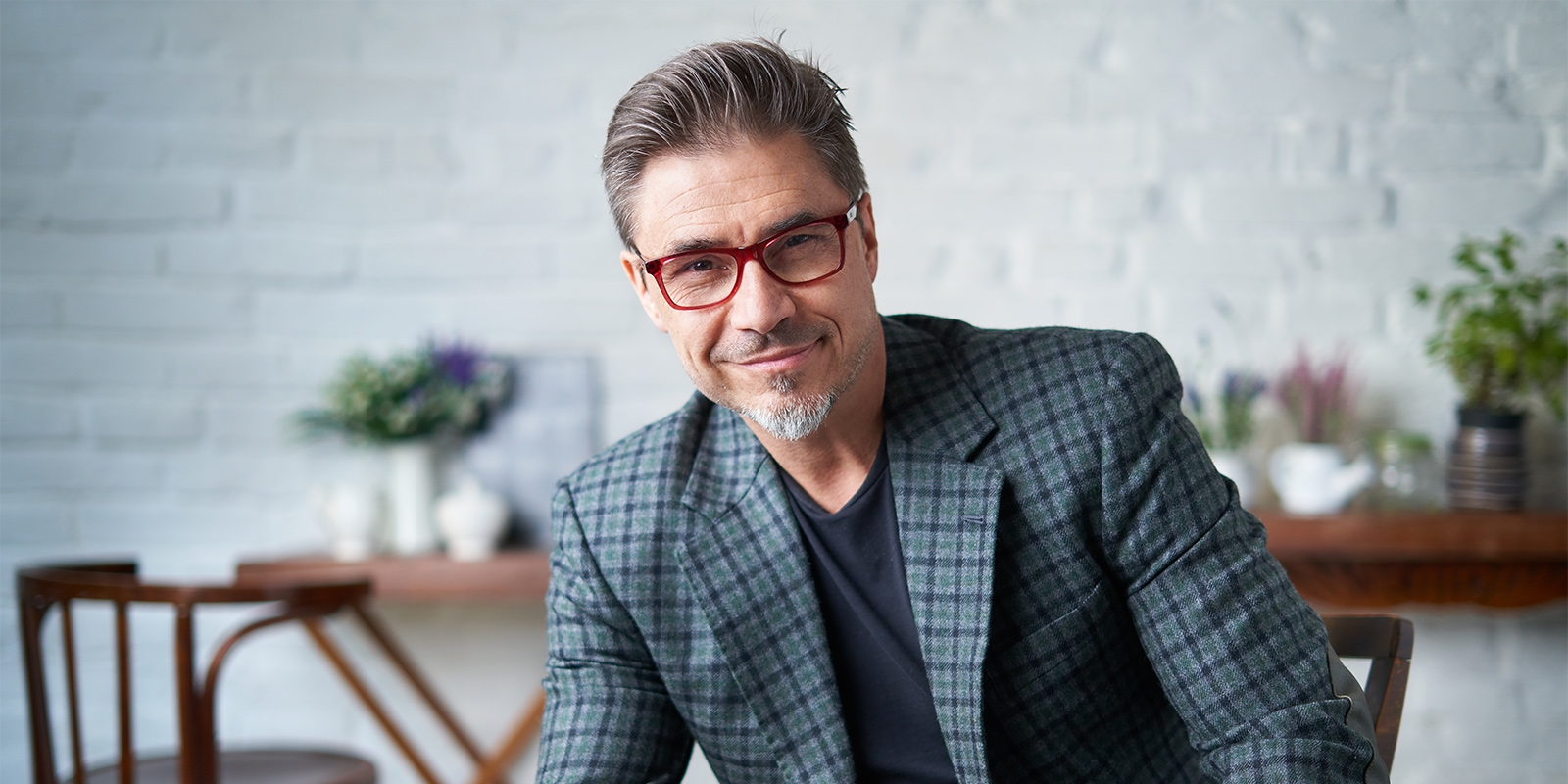 business man smiling and holding a phone