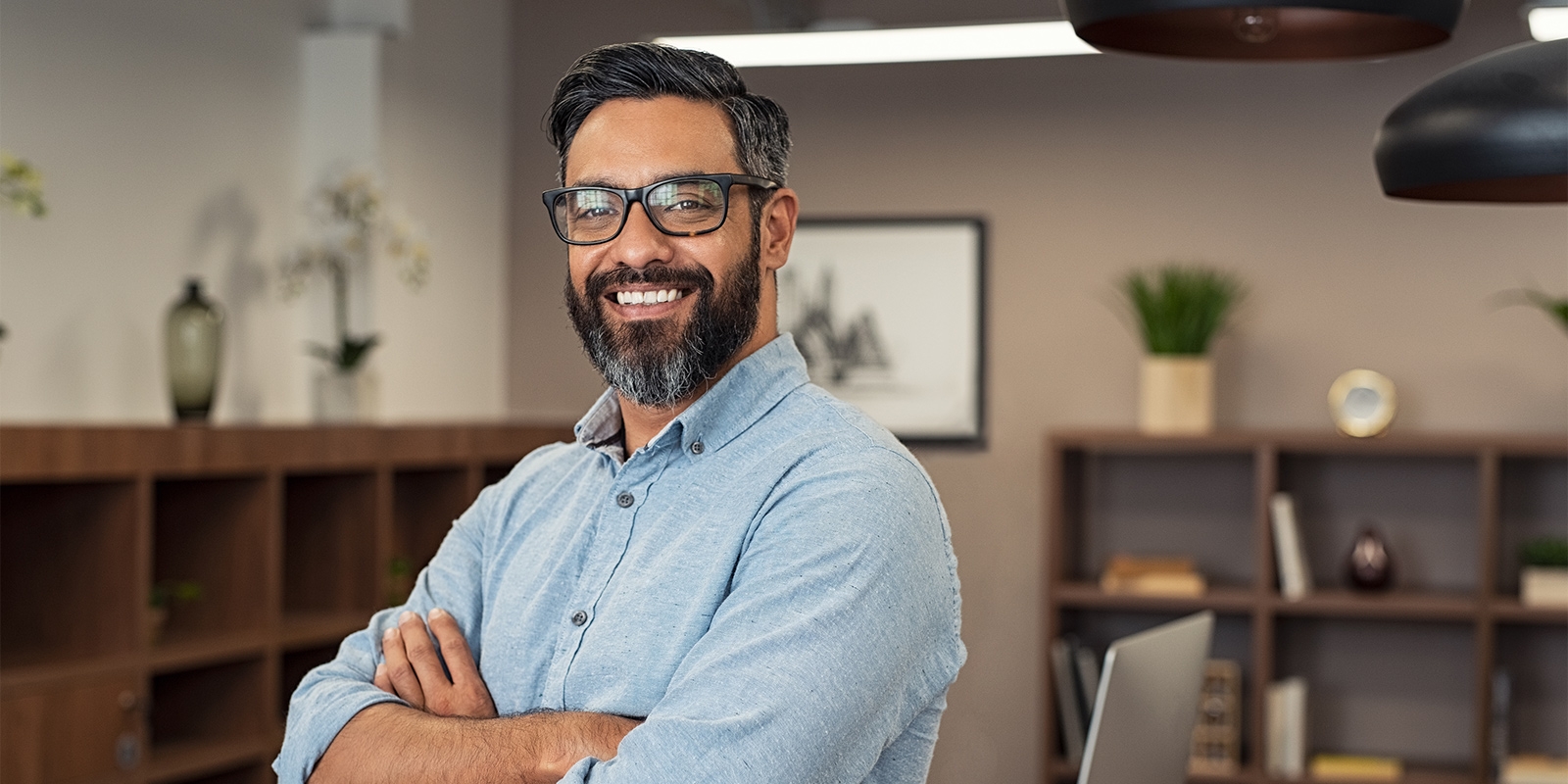 business man smiling with his arms crossed