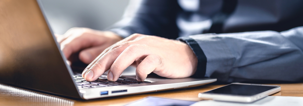 Person typing on computer learning about the Secure 2.0 Act chnages.