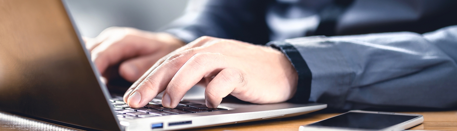 Person typing on computer learning about the Secure 2.0 Act chnages.