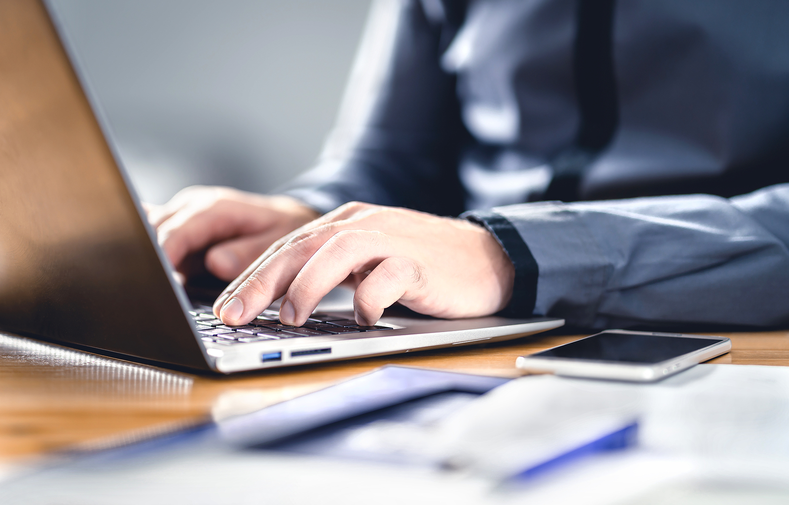 Person typing on computer learning about the Secure 2.0 Act chnages.